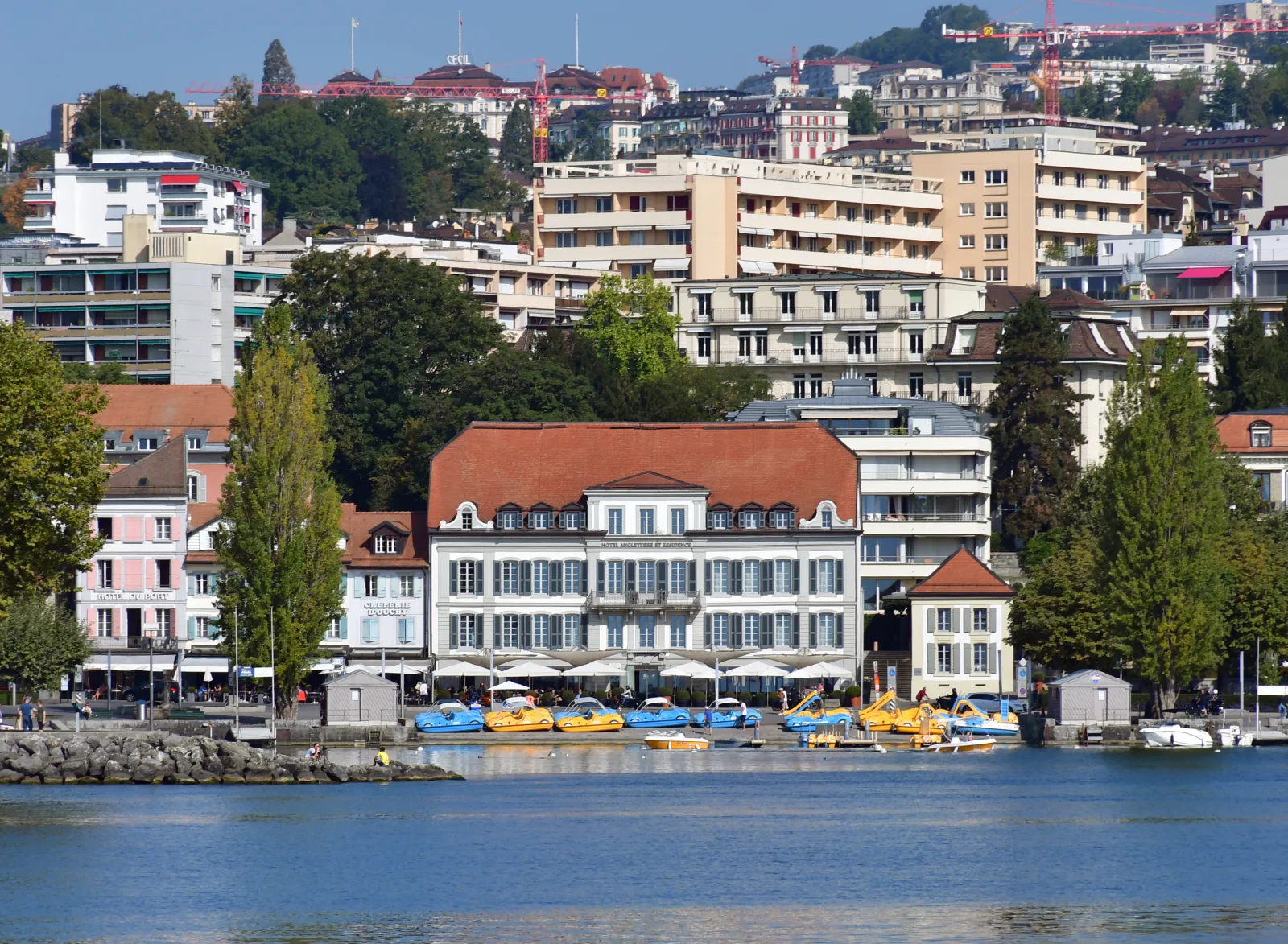 Hotels and buildings in downtown Lausanne, with an urban view and a lodging atmosphere.