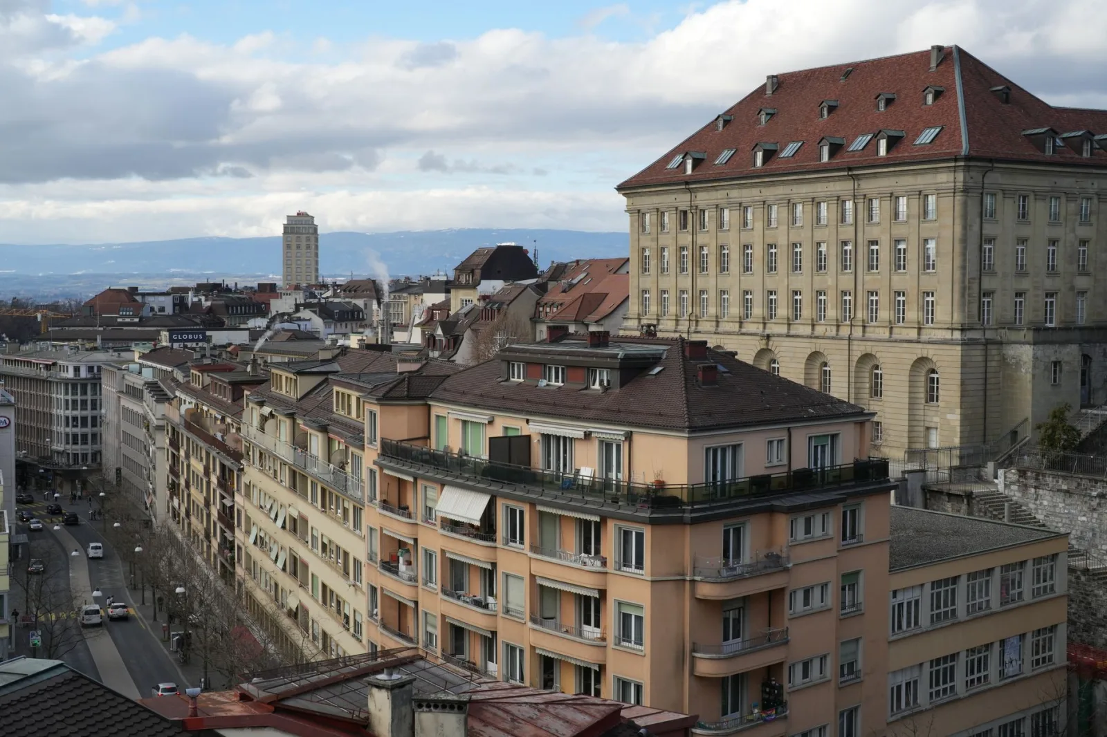 View of Lake Lausanne with boats and the Alps in the background