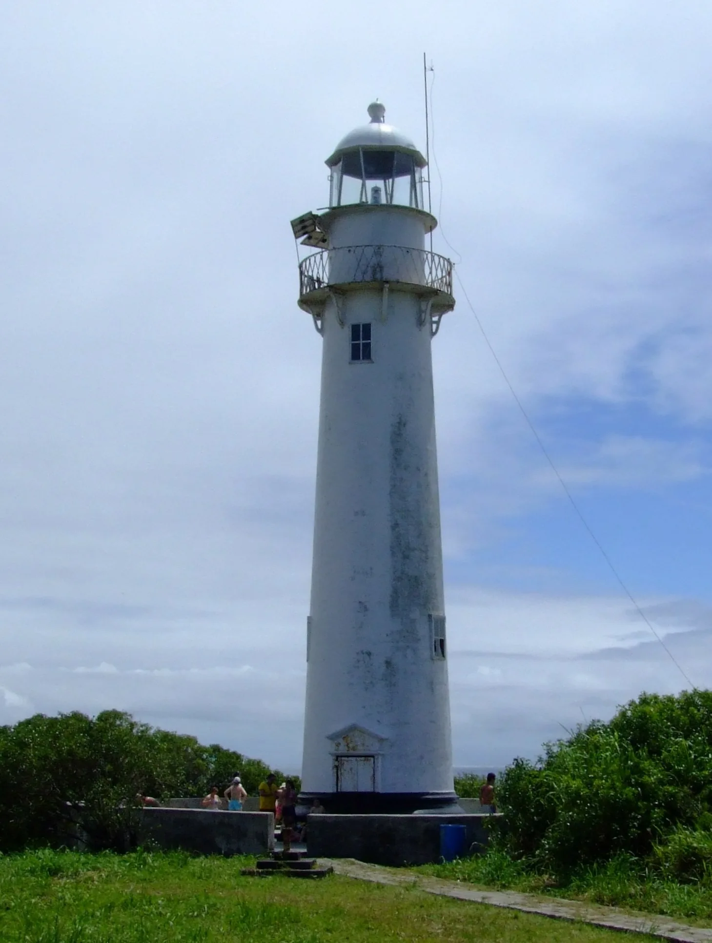 Farol das Conchas at the top of the forest on Ilha do Mel, with a view of the sea and a tourist trail.