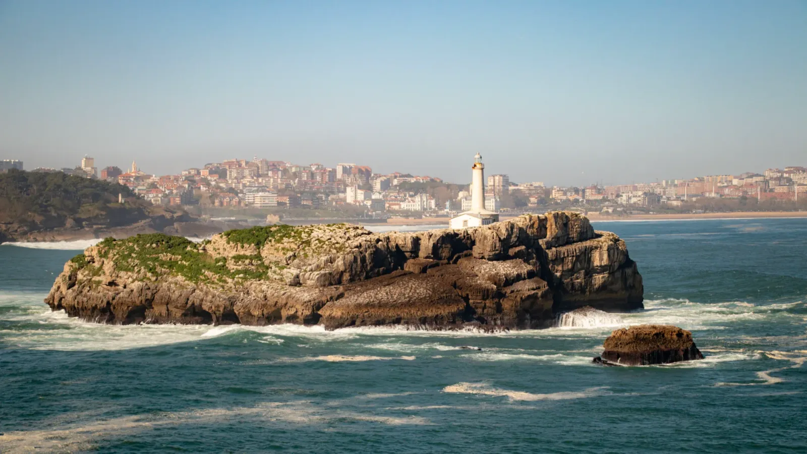 Santander waterfront with the sea, beach, and historic buildings in the background.