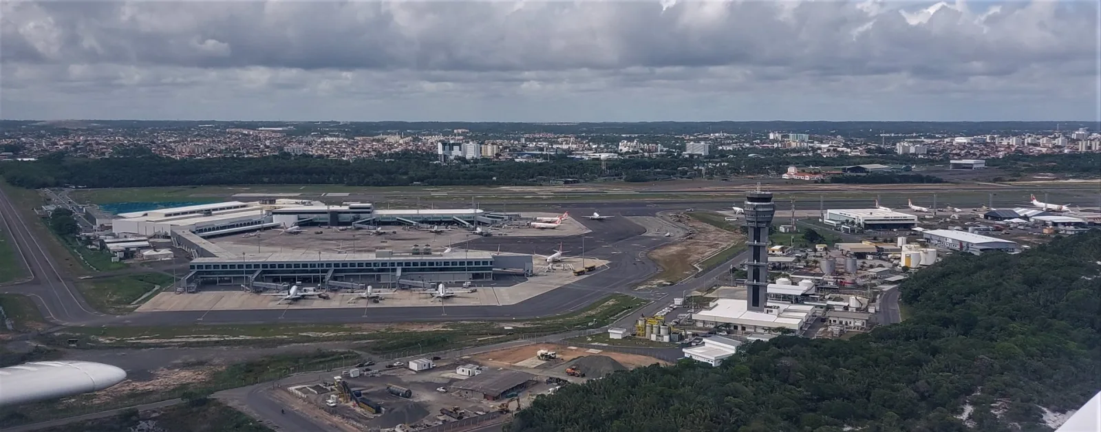 Salvador International Airport with an airplane landing on the runway.