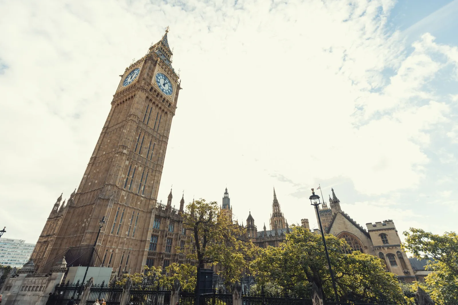 Panoramic view of London with Big Ben, the London Eye, and the River Thames in the background