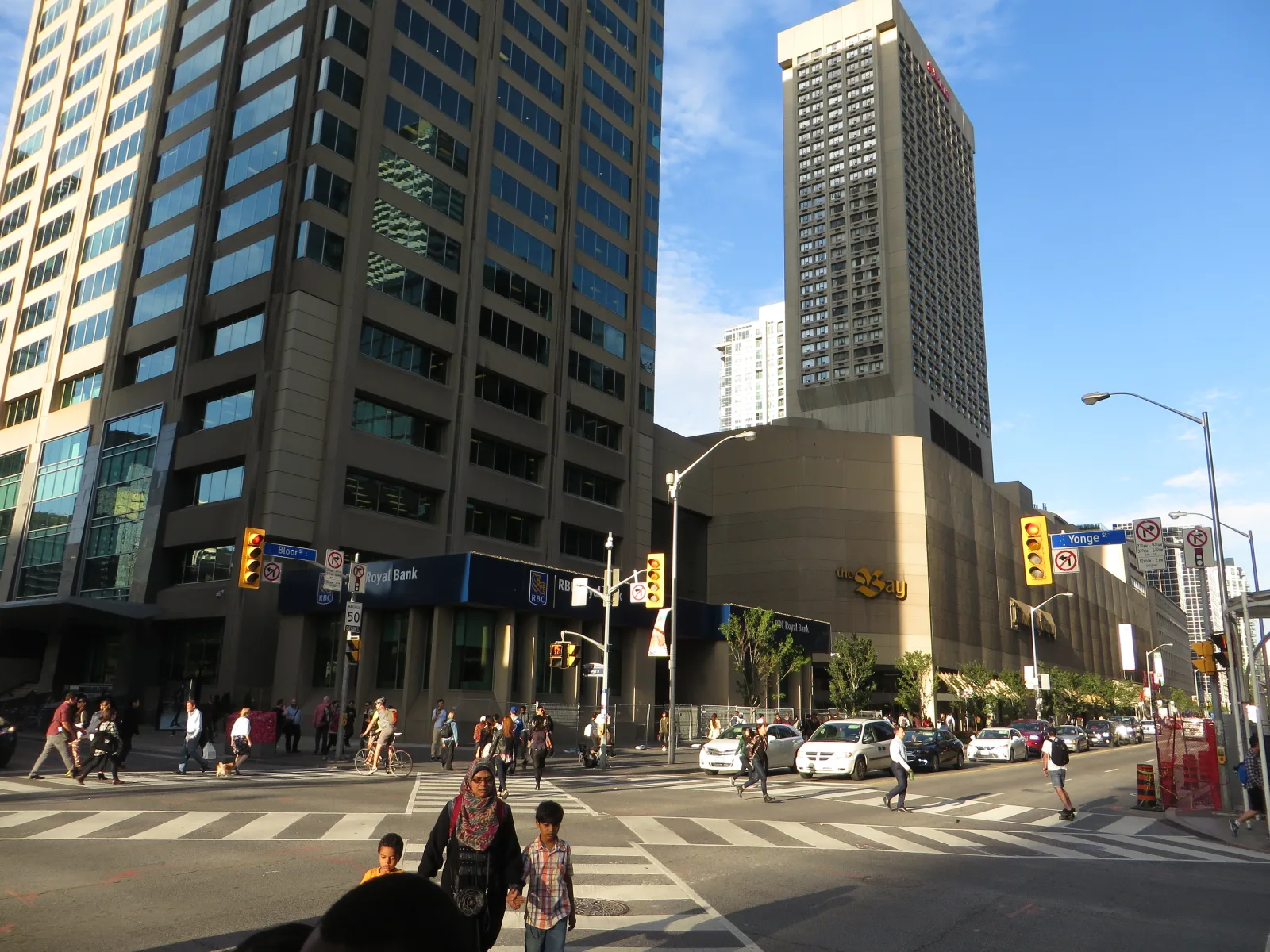 Toronto commercial street with storefronts and urban buildings in the background