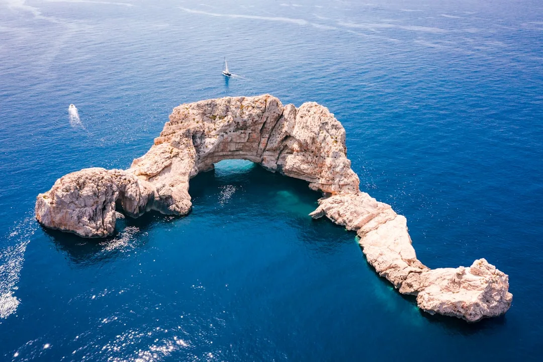 Car in Ibiza road with coastal landscape in the background, suggesting movement around the island