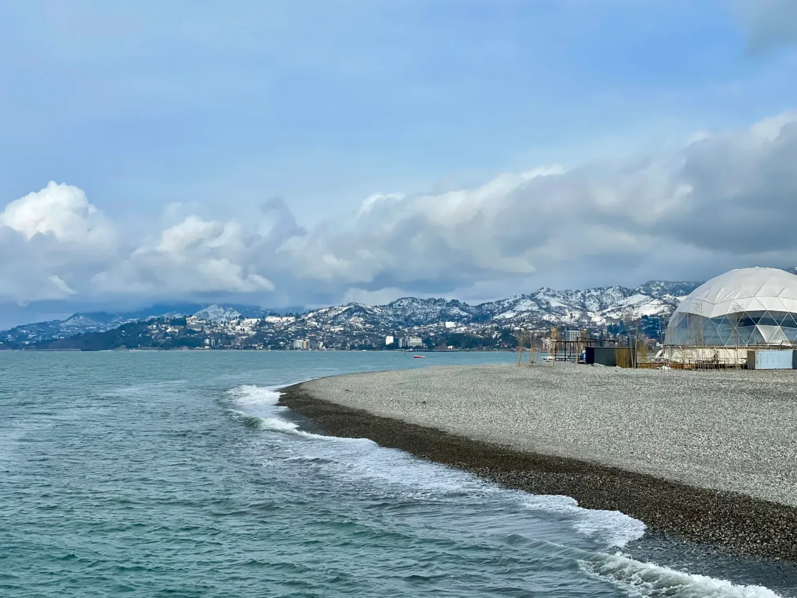 Seaside promenade in Batumi with people walking at sunset