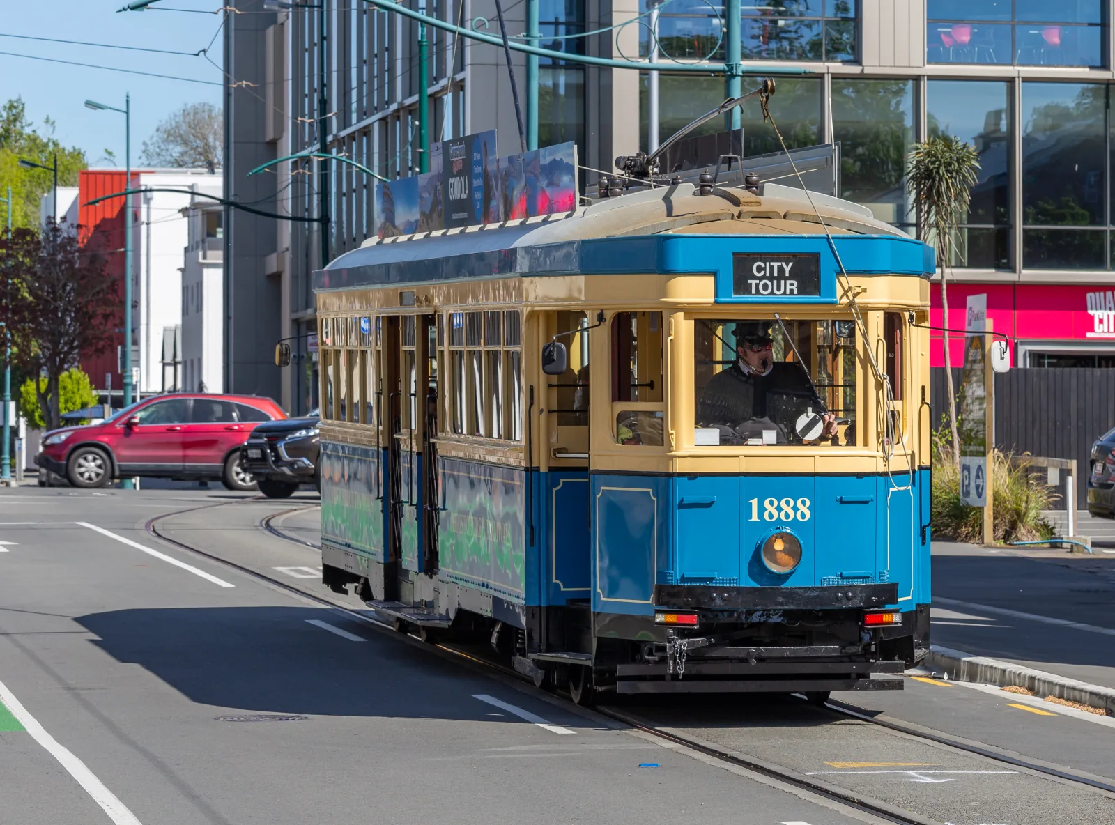 Christchurch city center with historic trams and surrounding urban architecture.