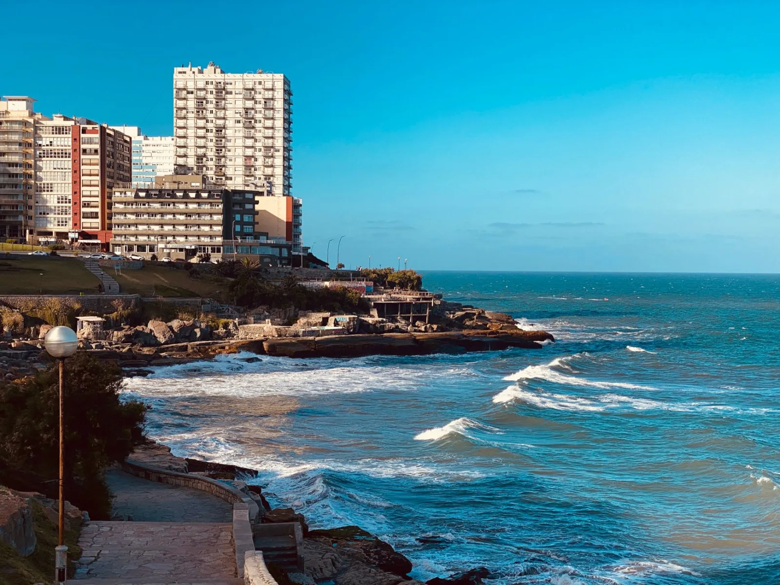 Mar del Plata beach with a bustling promenade and seaside beach clubs