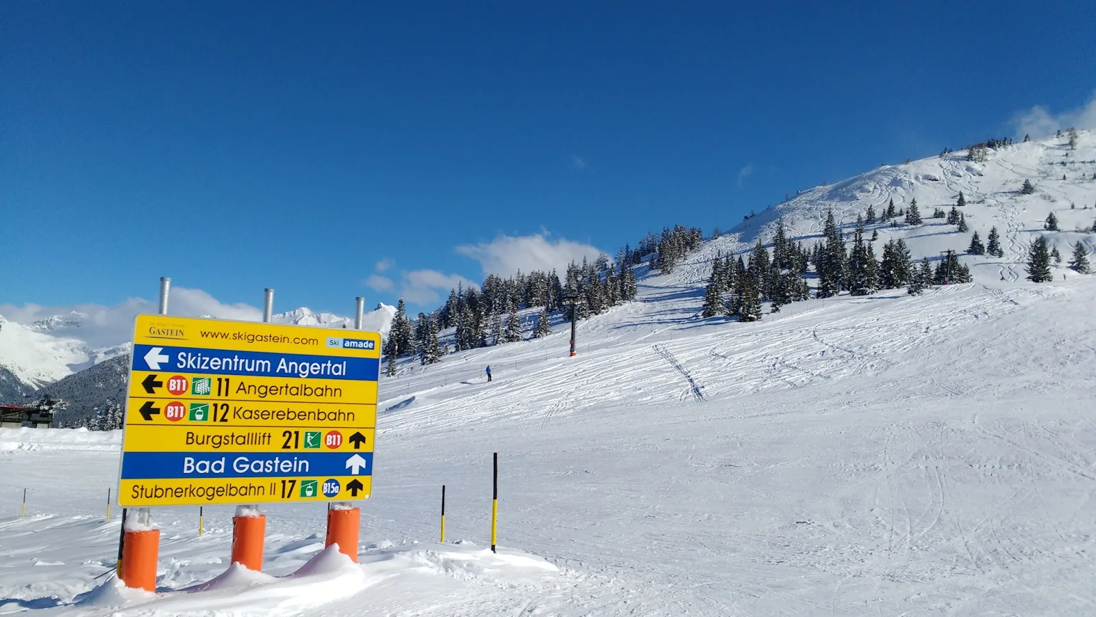 Ski slopes and ski lifts at the Bad Gastein resort, surrounded by snow-covered mountains.