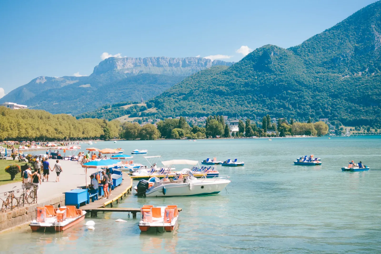 Canal with colorful houses and mountains in the background in Annecy, France