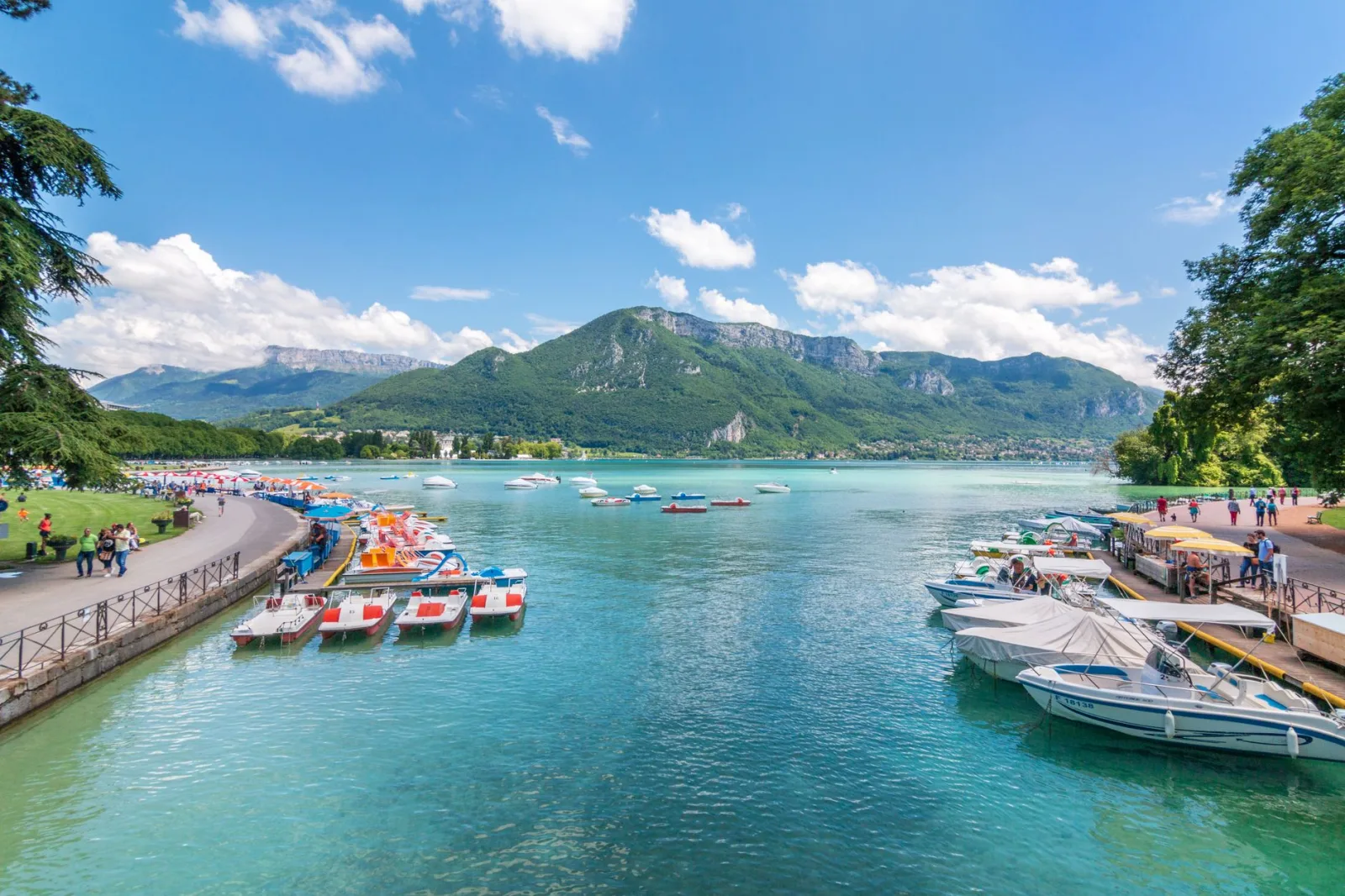 Lake Annecy with mountains in the background, on a clear summer day.