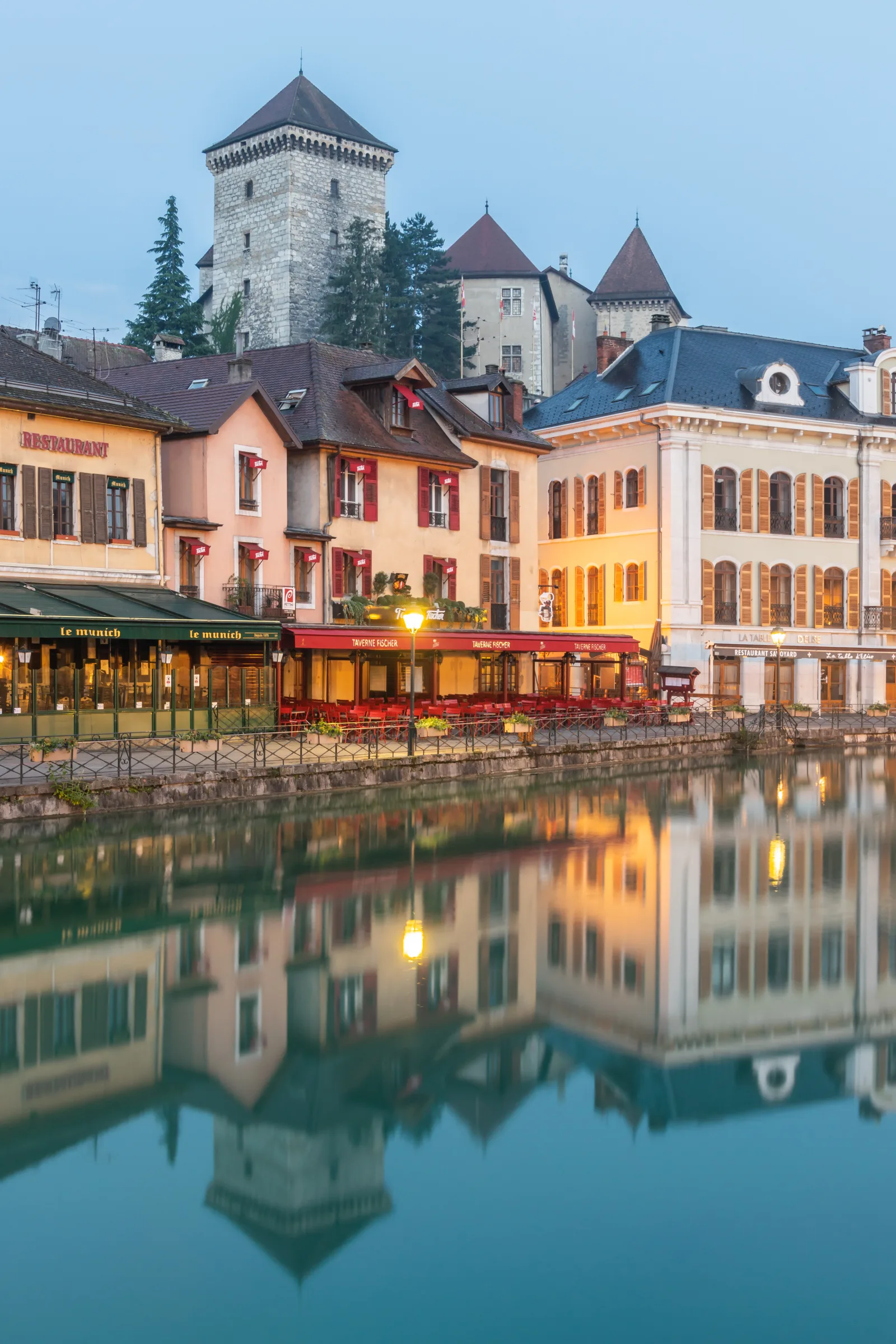 Canal in Annecy with boats and historic buildings along the banks