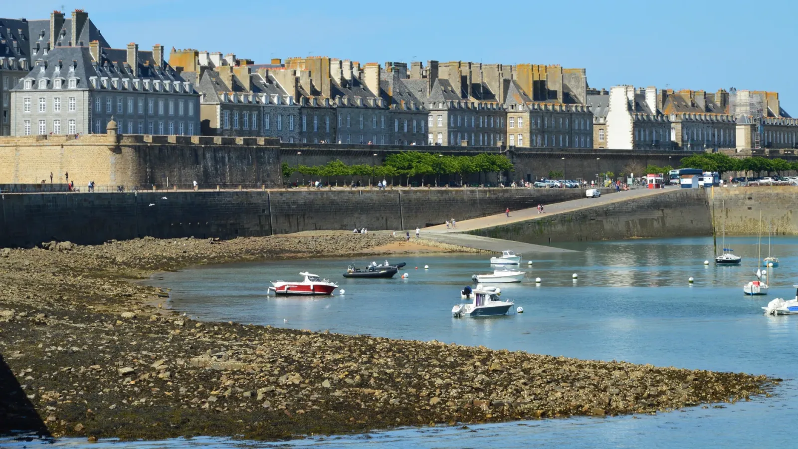 Walls of Saint-Malo surrounding the old town, with sea, beach, and harbor visible all around.