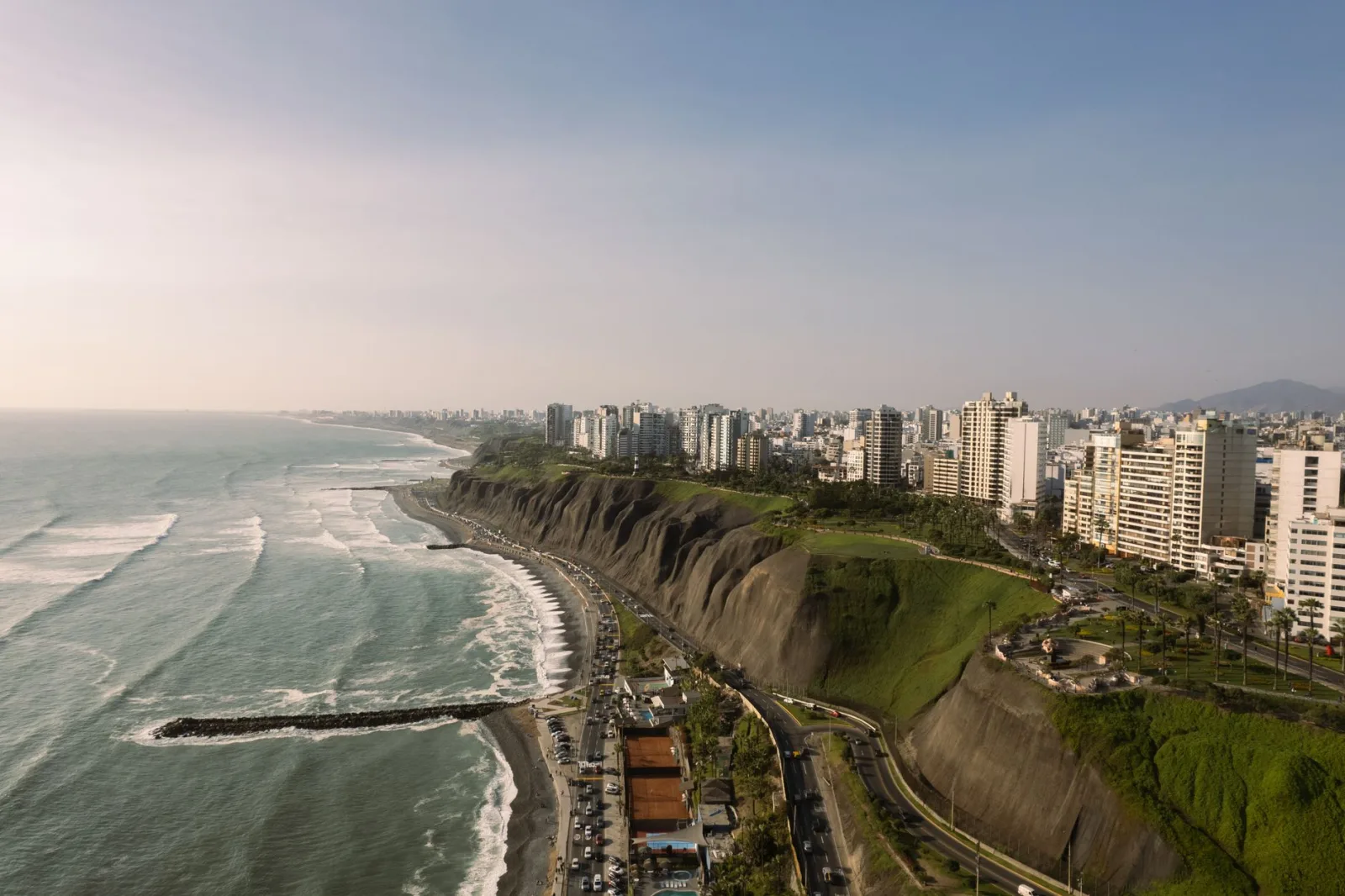 Vista panorámica de Lima con edificios junto al mar bajo cielo despejado