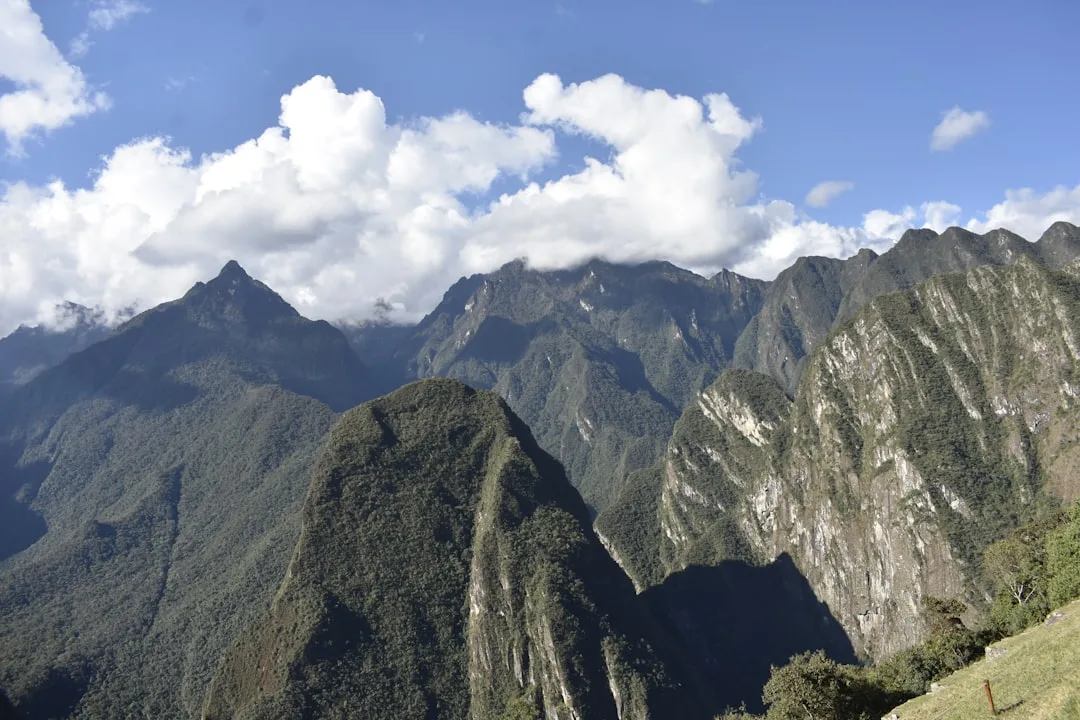 Tourist bus climbs the road from Aguas Calientes to the entrance of Machu Picchu, with mountains in the background