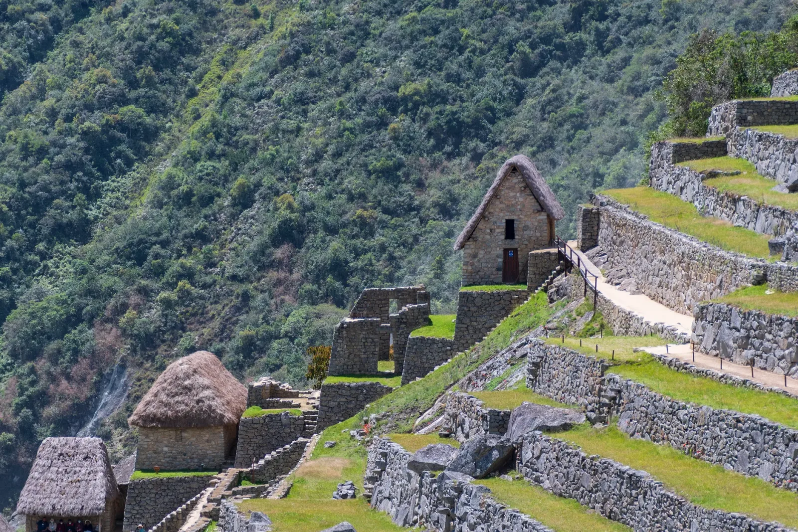 Aguas Calientes hot springs with visitors and mountains, a practical setting for planning the visit.