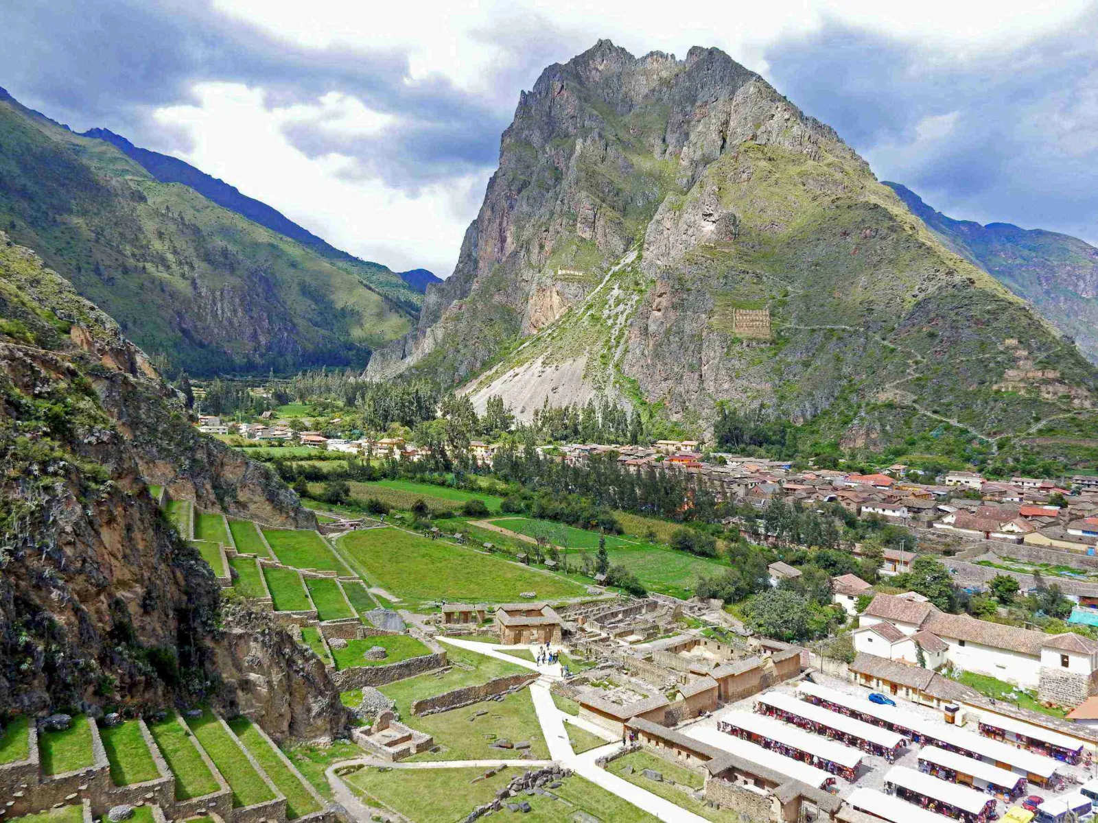 Inca ruins of Ollantaytambo with the Andean mountains in the background.