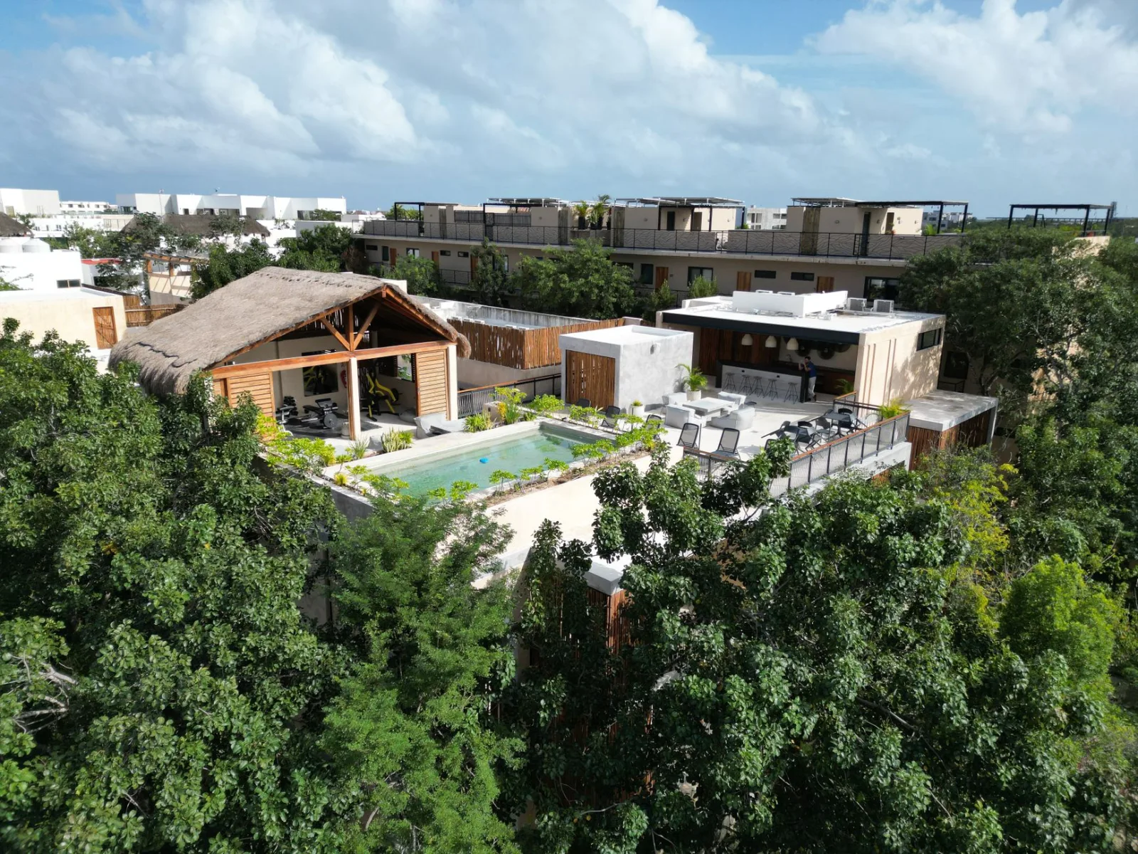 Bungalós a orillas del mar en Tulum, rodeados de palmeras y arena blanca.