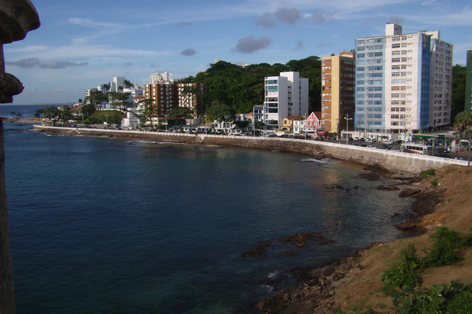 Salvador beach with calm sea, a stretch of sand, and clear waters near Farol da Barra.