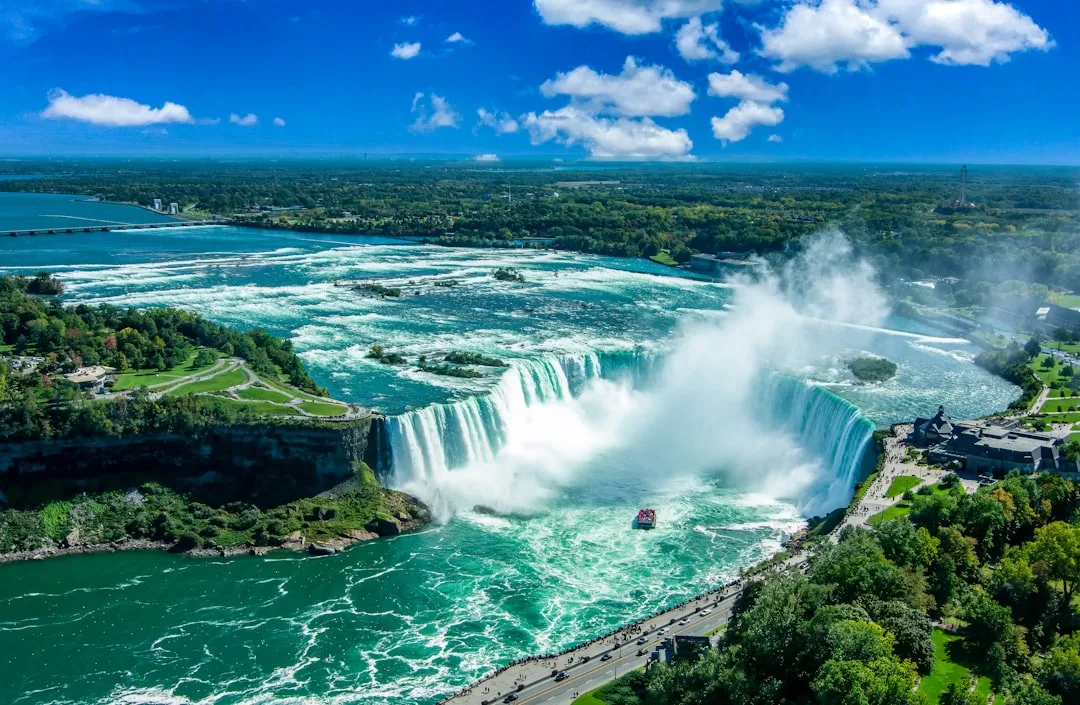 Cataratas del Niágara al atardecer, con miradores y luces reflejándose en el agua.