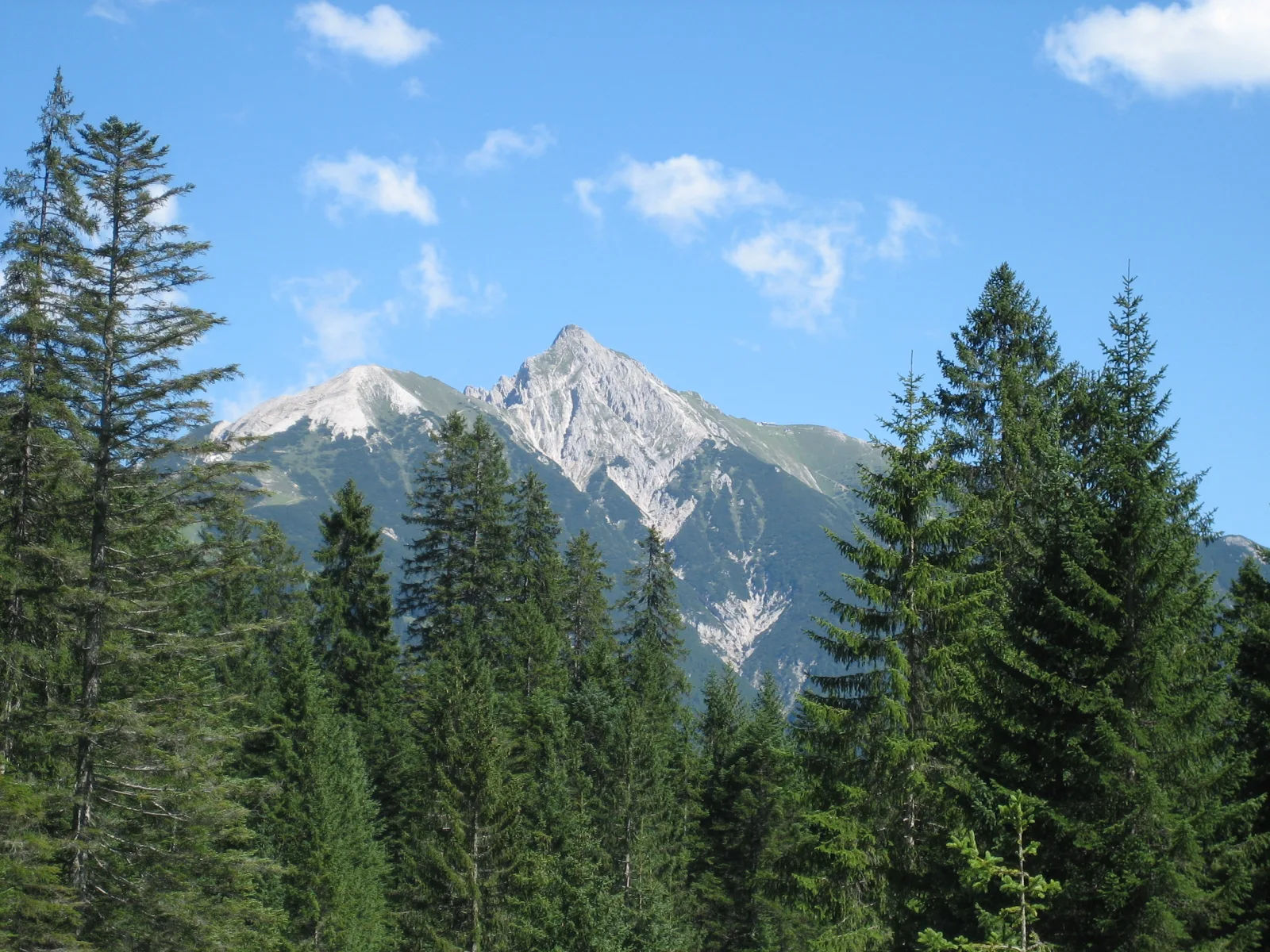 Alpine café in Seefeld with outdoor tables and mountains in the background.